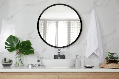 Miroir rond avec un cadre noir