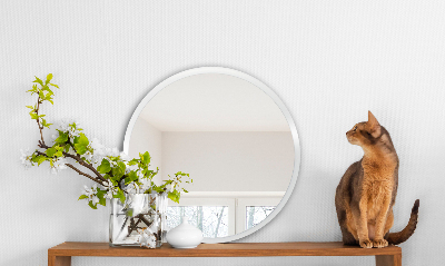Miroir rond avec un cadre blanc