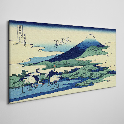 Tableau imprimé sur toile Grues près d'une montagne