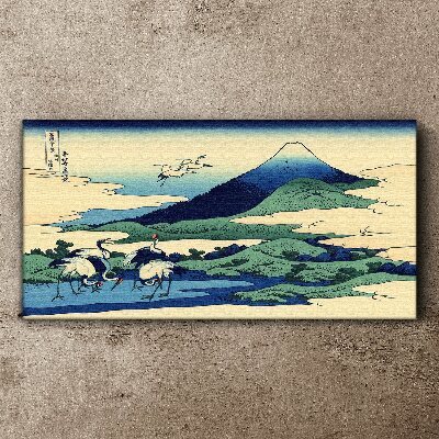 Tableau imprimé sur toile Grues près d'une montagne