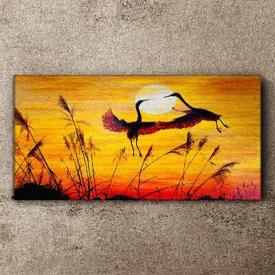 Tableau sur toile Grues dansantes au coucher du soleil