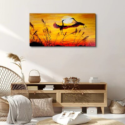 Tableau sur toile Grues dansantes au coucher du soleil