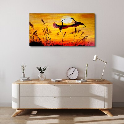 Tableau sur toile Grues dansantes au coucher du soleil