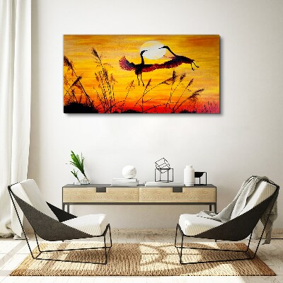 Tableau sur toile Grues dansantes au coucher du soleil