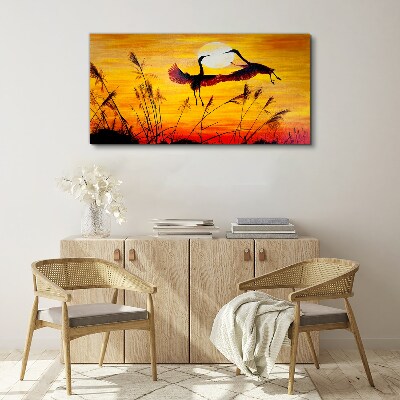 Tableau sur toile Grues dansantes au coucher du soleil