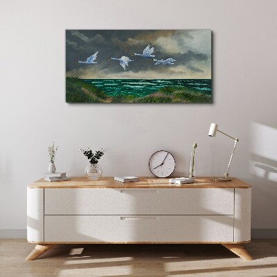 Tableau imprimé sur toile Vol de cygnes au dessus de la mer