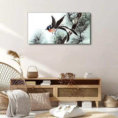 Tableau sur toile Un oiseau en vol au-dessus des pins