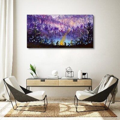 Tableau sur toile La magie d'un feu de camp en soirée dans la forêt