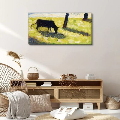 Tableau toile imprimée Une vache broutant dans un paysage verdoyant
