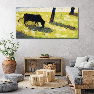 Tableau toile imprimée Une vache broutant dans un paysage verdoyant