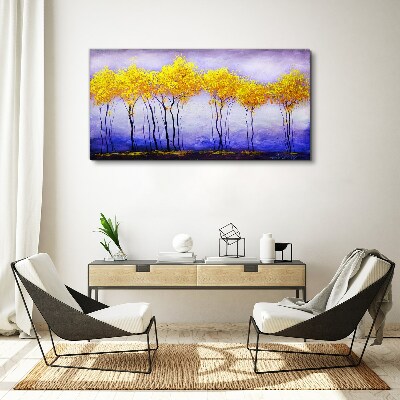 Tableau sur toile Des arbres dorés dans un paysage violet