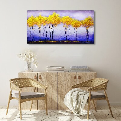 Tableau sur toile Des arbres dorés dans un paysage violet