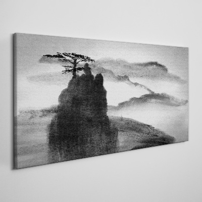 Tableau sur toile Un arbre solitaire sur une montagne rocheuse