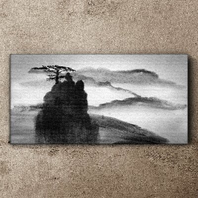Tableau sur toile Un arbre solitaire sur une montagne rocheuse