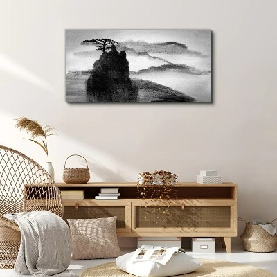 Tableau sur toile Un arbre solitaire sur une montagne rocheuse