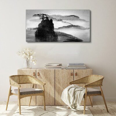 Tableau sur toile Un arbre solitaire sur une montagne rocheuse