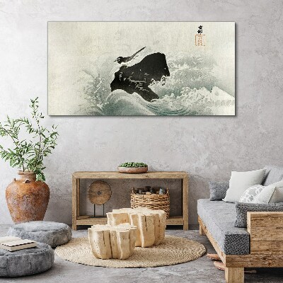 Tableau toile imprimée Un oiseau sur un rocher dans les vagues