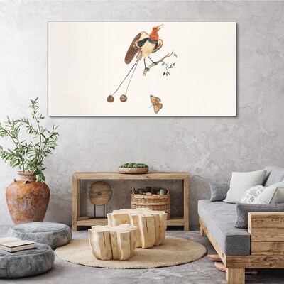 Tableau imprimé sur toile Un oiseau sur une branche avec des fruits