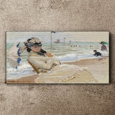 Tableau sur toile Femme sur la plage avec un parasol
