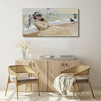 Tableau sur toile Femme sur la plage avec un parasol