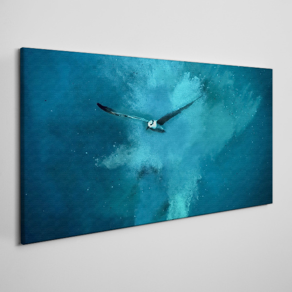 Tableau sur toile Un oiseau dans l'espace bleu