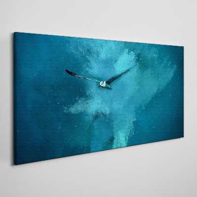 Tableau sur toile Un oiseau dans l'espace bleu