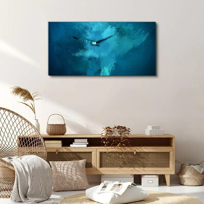 Tableau sur toile Un oiseau dans l'espace bleu