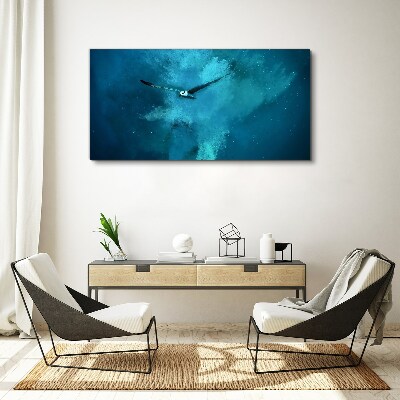 Tableau sur toile Un oiseau dans l'espace bleu