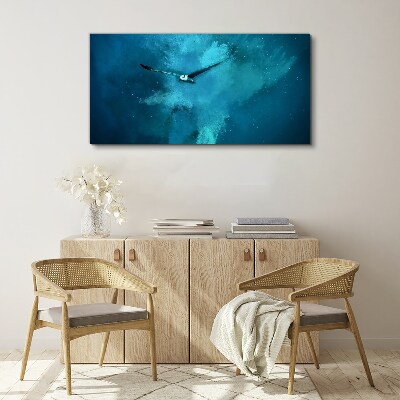 Tableau sur toile Un oiseau dans l'espace bleu