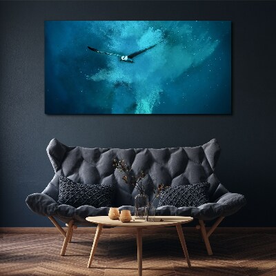 Tableau sur toile Un oiseau dans l'espace bleu