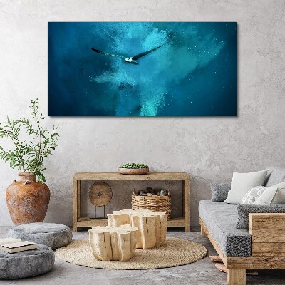 Tableau sur toile Un oiseau dans l'espace bleu