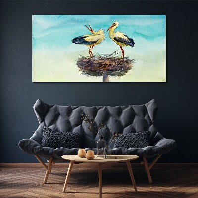 Tableau toile imprimée Cigognes sur un nid dans le bleu