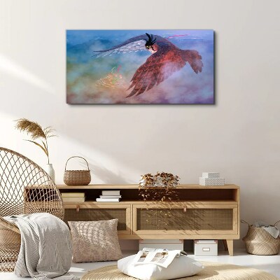 Tableau imprimé sur toile Vol d'un oiseau de proie dans les nuages