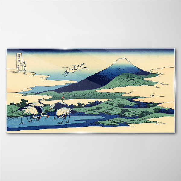 Tableau imprimé sur verre Grues près d'une montagne