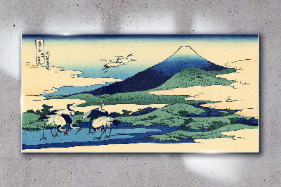 Tableau imprimé sur verre Grues près d'une montagne