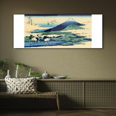 Tableau imprimé sur verre Grues près d'une montagne