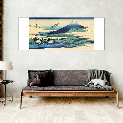 Tableau imprimé sur verre Grues près d'une montagne
