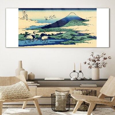 Tableau imprimé sur verre Grues près d'une montagne