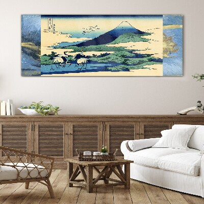 Tableau imprimé sur verre Grues près d'une montagne