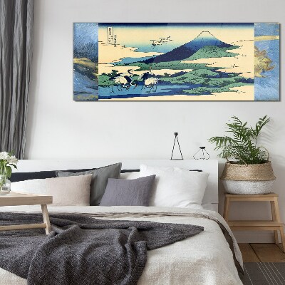 Tableau imprimé sur verre Grues près d'une montagne