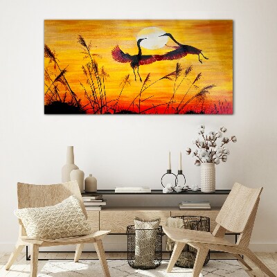 Tableau sur verre Grues dansantes au coucher du soleil