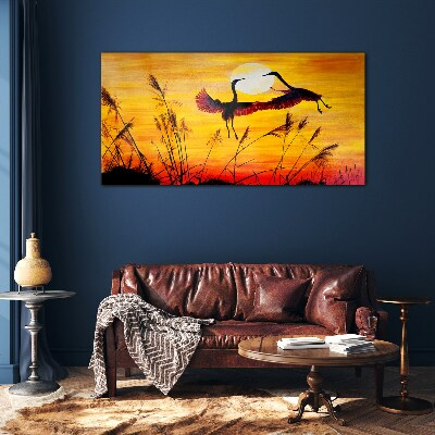 Tableau sur verre Grues dansantes au coucher du soleil