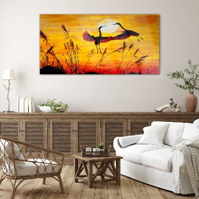 Tableau sur verre Grues dansantes au coucher du soleil