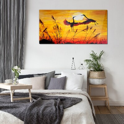 Tableau sur verre Grues dansantes au coucher du soleil
