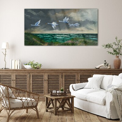 Tableau imprimé sur verre Vol de cygnes au dessus de la mer