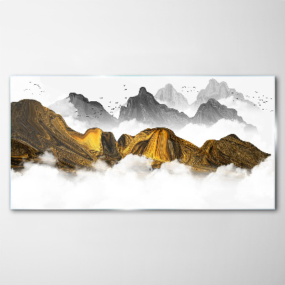 Tableau verre imprimé Des montagnes dorées dans les nuages