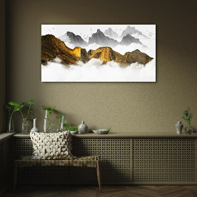 Tableau verre imprimé Des montagnes dorées dans les nuages