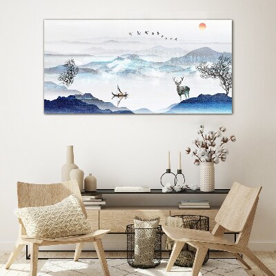 Tableau sur verre Un paysage de montagne paisible avec un cerf