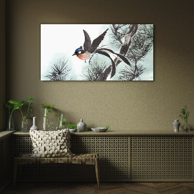 Tableau verre imprimé Un oiseau en vol au-dessus des pins