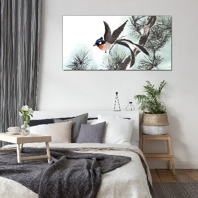 Tableau verre imprimé Un oiseau en vol au-dessus des pins